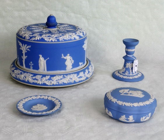 Three items of Wedgwood blue Jasperware, to include: candlestick, covered dish and a pin dish,