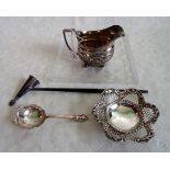 A Victorian silver milk jug on four ball supports, together with a silver sugar sifter,