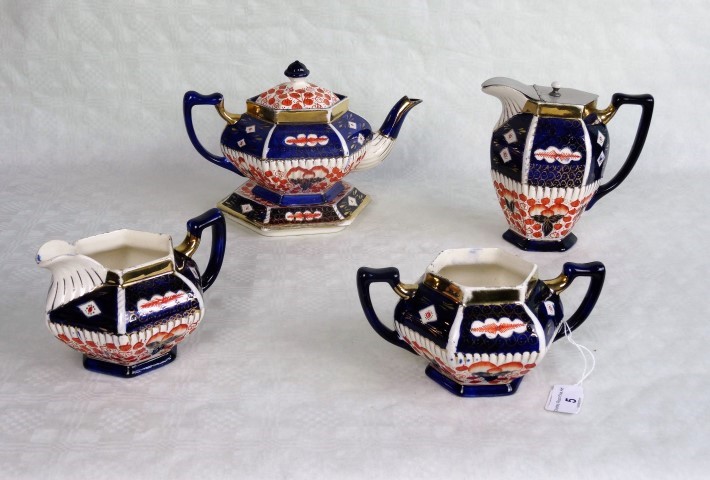 An Edwardian part-tea service, decorated in the Imari palette, comprising: teapot and stand,