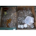 Two boxes containing a large quantity of drinking glasses, fruit bowls, jars and other items.