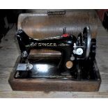 An early 20th century boxed Singer sewing machine.