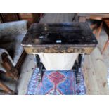 An early 20th century ebonised work table, decorated in the Oriental manner (AF), 62cm wide.