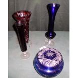 Four pieces of ruby and blue coloured glass, to include vases and a covered jar.