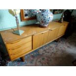 A circa 1970's G-Plan style sideboard, having two central cupboard doors,