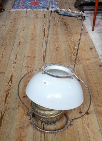 A brass ceiling oil lamp and opaline shade.