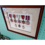 A framed and glazed WWII medal presentation group, to include: Campaign medal, 1939/45 Star,