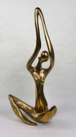 A large African gilt metal (possibly bronze) abstract study of a female seated figure with