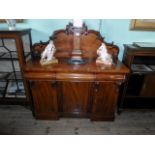 A Victorian mahogany chiffonier, having scroll back over three drawers and cupboard doors,