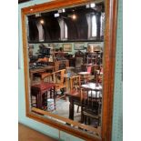 A large walnut framed wall mirror, the bevel edged glass measuring 52cm x 74cm.