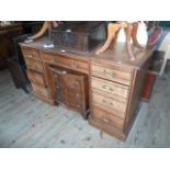 A Victorian oak nine drawer desk, 136cm wide.