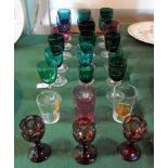 A harlequin suite of coloured wine glasses and other items.