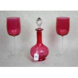 A cranberry glass decanter and stopper,