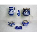 Six pieces of 19th century Wedgwood Jasperware, each on a deep blue ground,