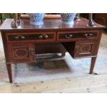 An Edwardian mahogany and inlaid dressing table base, having two drawers over two cupboard doors,