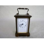 A French gilt brass carriage clock, having five bevel edged glass panels,