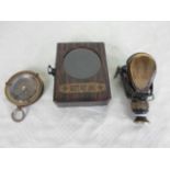 A reproduction wooden cased brass compass, the case bearing German military insignia,