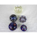 Five glass paperweights, to include an example by Caithness, the largest 10cm diameter.