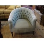 An Edwardian button back green upholstered tub chair, 75cm wide.