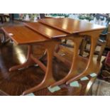 A set of three mid-20th century G-plan style nesting tables, the largest 56cm wide.