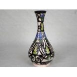 A contemporary Moorcroft vase, having tube-lined stylized bramble decoration on an ivory ground,