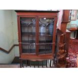 An Edwardian mahogany and inlaid two door display cabinet on tapering supports, 94cm wide.