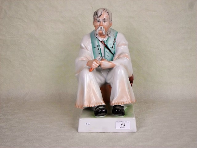 A large 20th century Zsolnay Pecs ceramic figure of a seated man, printed marks to base, 32cm.