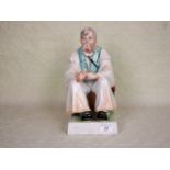 A large 20th century Zsolnay Pecs ceramic figure of a seated man, printed marks to base, 32cm.