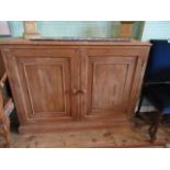 A pine two door cupboard, 114cm wide.