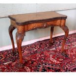 A reproduction walnut fold-over card table,