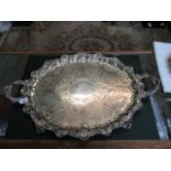 A late Victorian twin handled oval silver tray of imposing proportions,