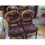 A set of four mahogany balloon back upholstered dining chairs, on turned supports, 42cm wide.