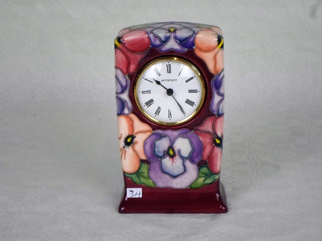 A contemporary Moorcroft clock, in the Pansy pattern by Rachel Bishop,