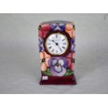 A contemporary Moorcroft clock, in the Pansy pattern by Rachel Bishop,