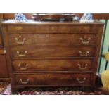 An early 19th century mahogany and inlaid chest, having four graduated drawers on bracket feet,