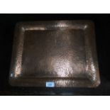 A late 19th/early 20th century beaten copper rectangular tray, signed Joseph Heinrichs,