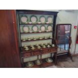 An early 20th century oak dresser, having three plate shelves over two drawers and galleried recess,