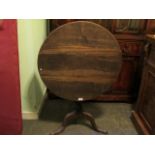 A Georgian circular tilt-top walnut and mahogany table on tri-form base, 70cm diameter.