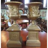 A pair of gilt metal pedestal urns of campagna form, mounted on plinth, 38cm.