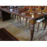 An Edwardian oak extending dining table on turned supports, 206cm extended.