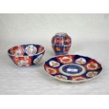 An early 20th century Japanese Imari plate, 22cm diameter, together with a small vase and bowl,