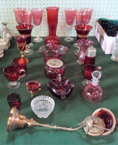 A large quantity of cranberry coloured glass, to include: vases, a scent bottle,