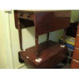 A Victorian single drawer drop flap table on turned supports,