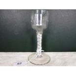 An early 19th century wine glass, the faceted bowl over cotton twist stem on a circular foot, 14cm.