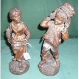 A pair of bronzed figurines, modelled as children on naturalistic bases, 31cm.