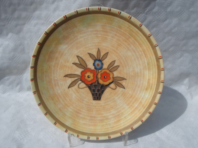 A 1930s Crown Ducal wall plaque, designed by Charlotte Rhead in the 6198 Basket pattern,