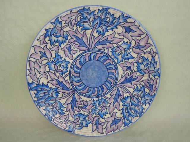 A large 1930s Crown Ducal wall plaque, designed by Charlotte Rhead in the 4016 Blue Peony pattern,