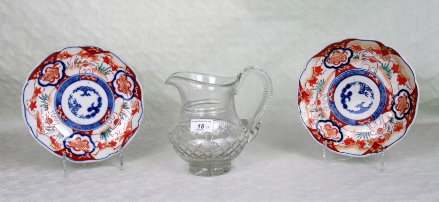 A pair of Japanese Imari plates, together with a cut glass water jug.