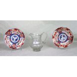 A pair of Japanese Imari plates, together with a cut glass water jug.