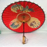 An early 20th century Japanese wood handled paper parasol, 58cm.
