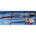 A collection of three reproduction swords of varying style.